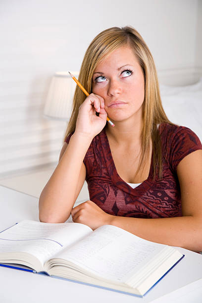 istock Teenage Girl Doing Homework 121877947