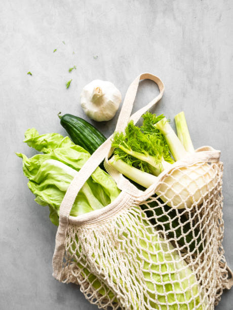 istock Green vegetables in a reusable shopping bag on a gray table 1218779838