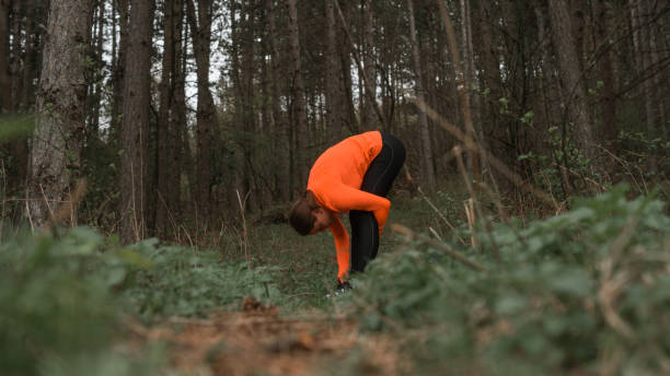 istock Female athlete stretching outdoors 1218781310