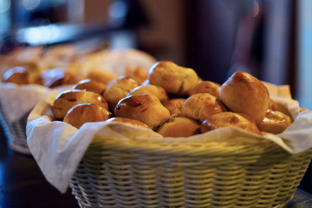 istock buns in basket - little fresh buns in basket on table 1218783813