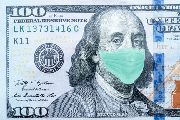 istock Benjamin Franklin With Worried and Concerned Expression Wearing Medical White  Face Mask On One Hundred Dollar Bill 1218784396