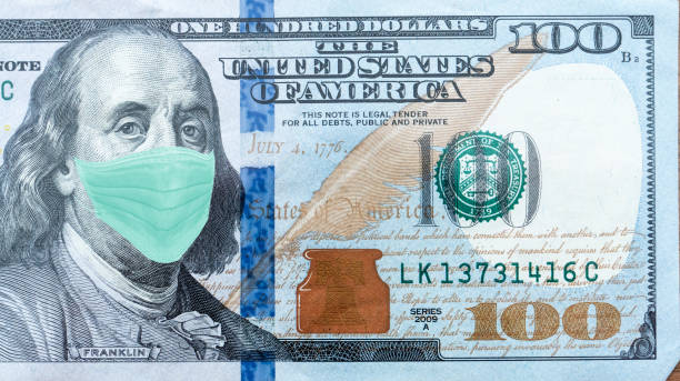 istock One Hundred Dollar Bill With Medical Face Mask on Benjamin Franklin. 1218784429