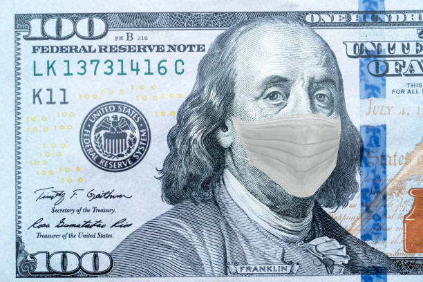 istock Benjamin Franklin With Worried and Concerned Expression Wearing Medical White  Face Mask On One Hundred Dollar Bill 1218784449