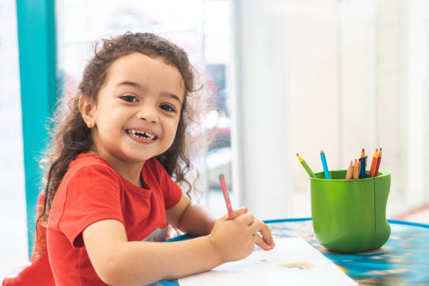 Little girl drawing with colorful pencils Little girl drawing with colorful pencils in daycare community center photos stock pictures, royalty-free photos & images