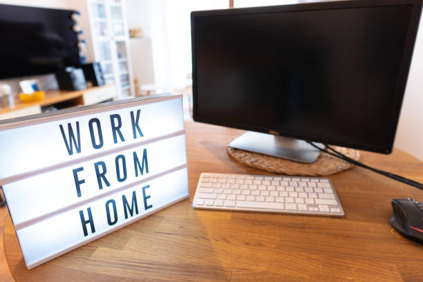 istock Working from home remote work inspirational social media lightbox message board next to monitor and keyboard and mouse, COVID-19 quarantine closure of all. Apartment background 1218785956