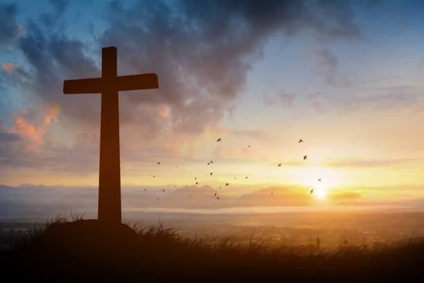 istock The cross with sunset in the sky background 1218786377