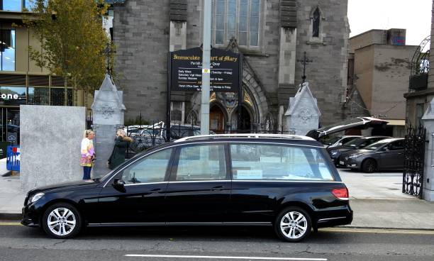 Empty hearse 13th April 2020, Dublin, Ireland. Empty hearse outside the Immaculate Heart of Mary Church on City Quay, Dublin Docklands, Dublin city centre. hearse photos stock pictures, royalty-free photos & images