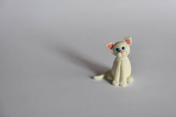 istock white little cat figurine on white background 1218787846