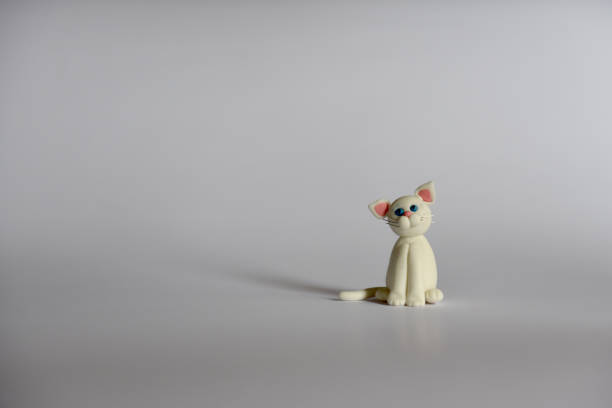 istock white little cat figurine on white background 1218787919