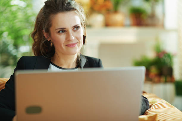 istock pensive woman looked aside while writing on laptop 1218790152