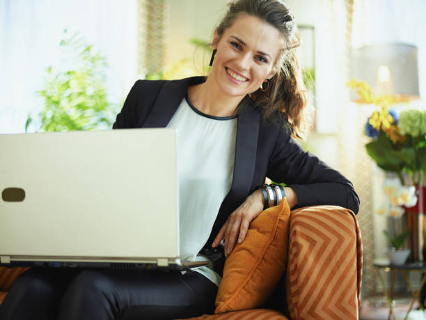 istock woman at modern home in sunny day reading while sitting on sofa 1218791278