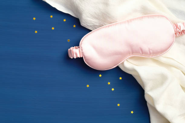 istock Sleep eye mask and blanket on dark blue background, top view. Insomnia, fall asleep concept. Flat lay, top view 1218791569