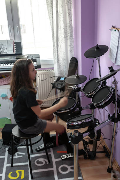 istock girl learn to play electronic drum 1218793065
