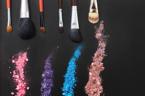 istock Eyeshadows and make up brushes on black background. Summer fashion style. Copy space 1218793082