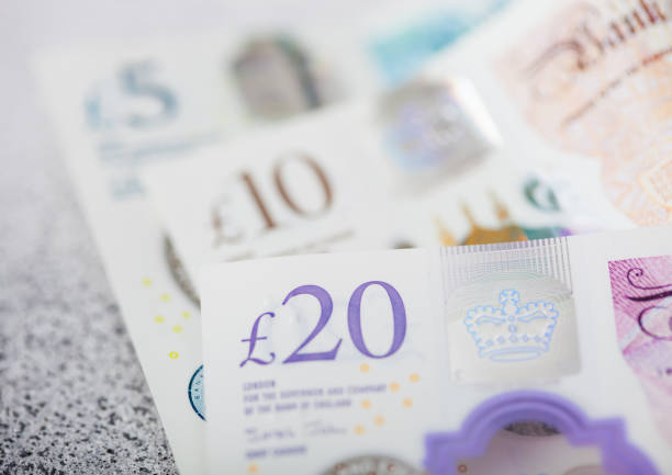istock New twenty, ten and five pounds banknotes close up on light background. 1218795210