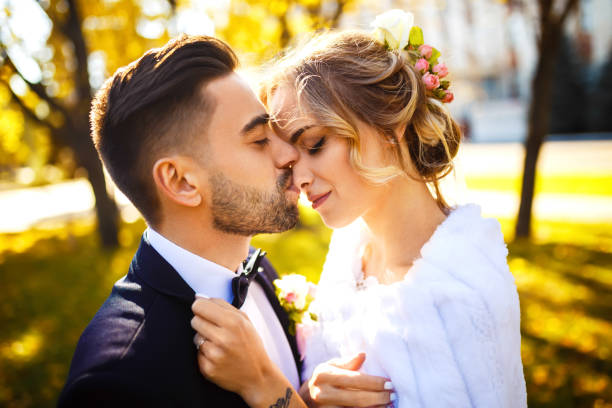 istock Young bride and groom enjoy each other in the park. 1218795219