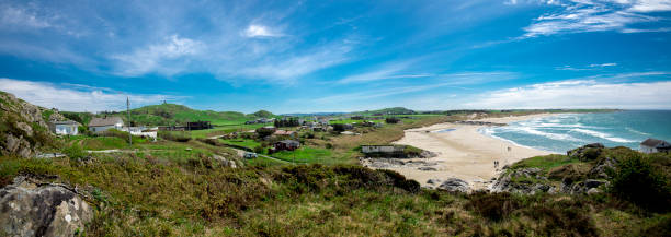 Panoramic view of a long Hellestostranden sand beach and surrounding area with green hills and fields near Stavanger city stock photo
