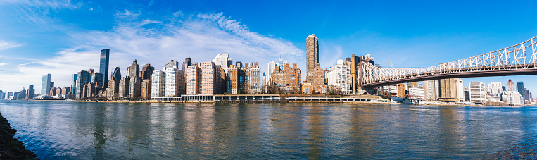 Upper east side of Manhattan waterfront with Queensboro bridge in New York City USA