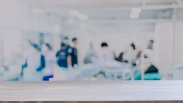 Photo of Doctor table top on Blurred Hospital background, Unrecognized Doctors and nurses are urgently helping emergency accident patients.,Emergency room bluured background