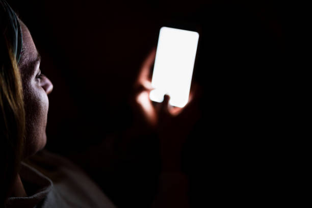 istock young woman at home using mobile phone. Night time 1218808749