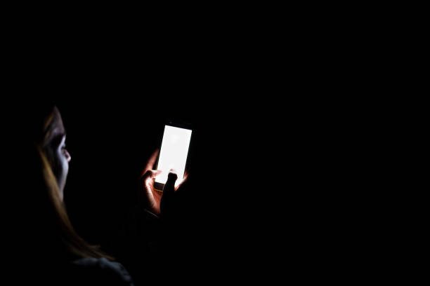 istock young woman at home using mobile phone. Night time 1218808761