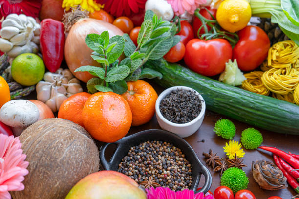 istock Colorful composition of assorted vegetables: tomato, egg,garlic,lemon,salad,mango,onion,lettuce, cabbage, onions, bell peppers,Studio photography. No people. Healthy eating concept. Organic and fresh food concept.on  background 1218813496