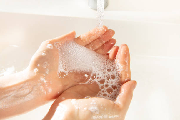 istock Woman washing hands with soap. Soap foam with bubbles 1218814141