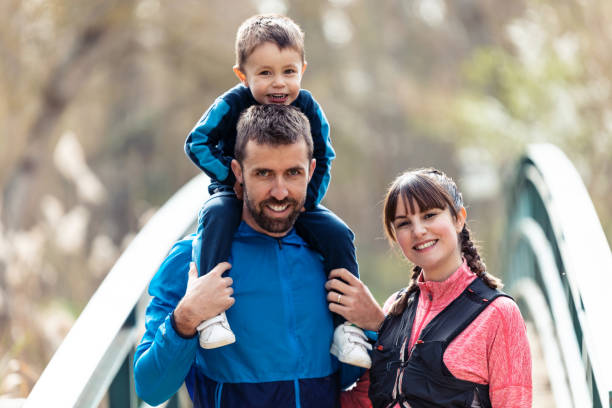 istock Happy young family looking at camera while spending time outdoor in spring. 1218814711