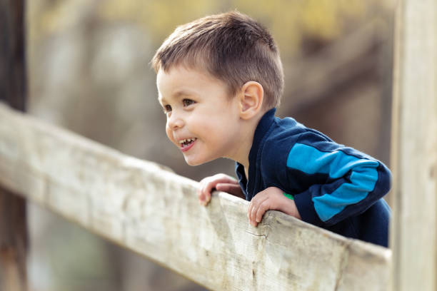 istock Nice little boy looking forward from the bridge outdoors. 1218814864