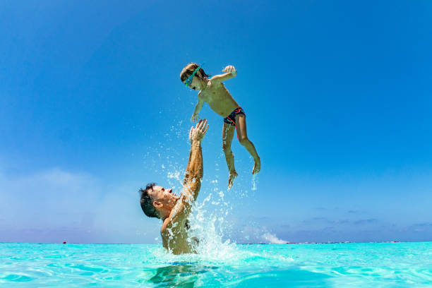 istock Dad is throwing son in the air 1218816707
