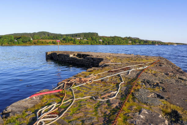 Stone pier at Isle of Skye, Scotland / UK Chains and ropes on a stone dock at Broadford, Isle of Skye, Scotland / UK isle of skye broadford stock pictures, royalty-free photos & images