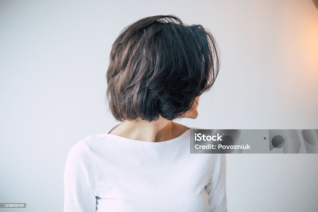 Cool Hairstyle Closeup Photo Of A Young Beautiful Girl With Short Dark Hair  Who Turned Away From The Camera And Shows Her New Hair Styling Stock Photo  - Download Image Now - iStock
