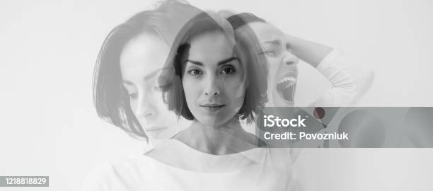 Multiple Identities Closeup Photo Of A Young Pretty Brunette Girl Who Is Looking In The Camera While Internally Suffering From A Dissociative Identity Disorder Double Exposure Stock Photo - Download Image Now