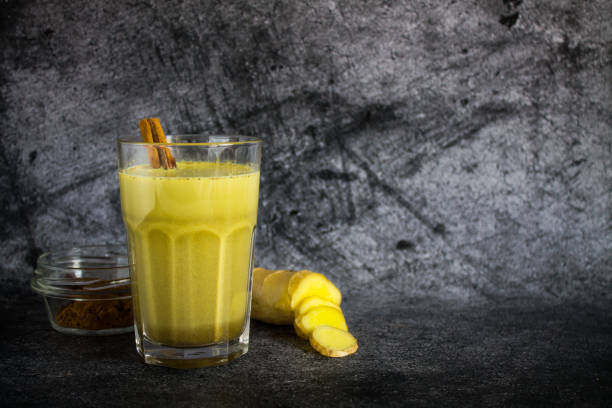 istock Golden milk in a clear glass and ginger root with a cinnamon stick 1218819061