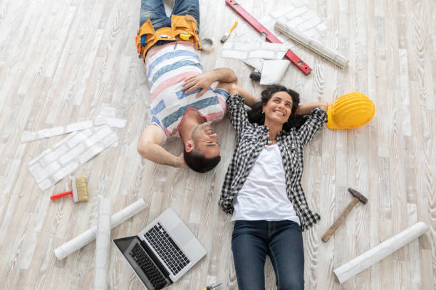 istock Couple renovating and resting on floor 1218819411