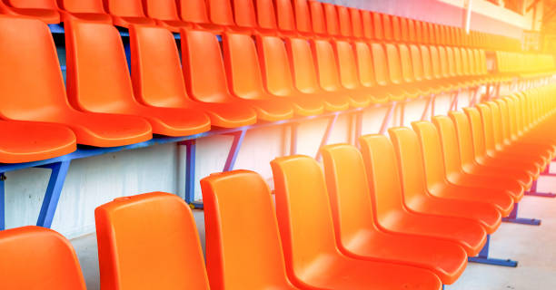 istock rows of empty orange stadium seats 1218820597