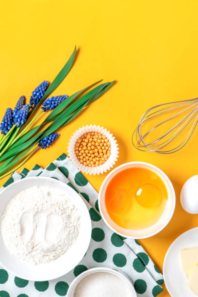 istock Ingredients for pastry and blue spring flowers on a orange background 1218820684