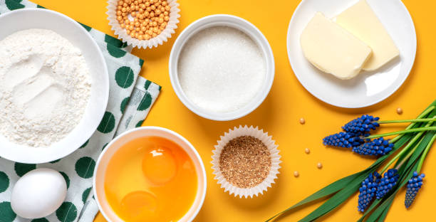istock Ingredients for pastry and blue spring flowers on a orange background 1218820754