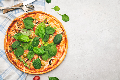 Italian pizza and various ingredients on wooden background with space on text