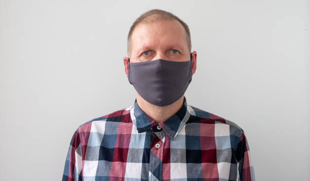 istock ordinary man wearing grey medical mask 1218820846