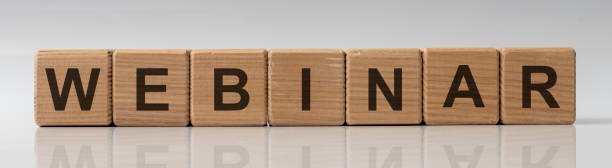 istock Webinar word on wooden cubes on white glossy background with reflection 1218820850