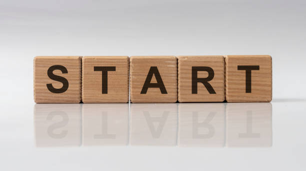 istock Word START made with wooden cubes, white background with reflection. 1218820853