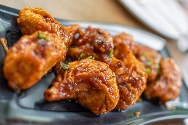 istock Pan fried chicken Momo served in a black plate over moody background. Selective focus 1218821117