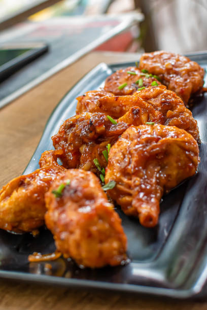 istock Pan fried chicken Momo served in a black plate over moody background. Selective focus 1218821129
