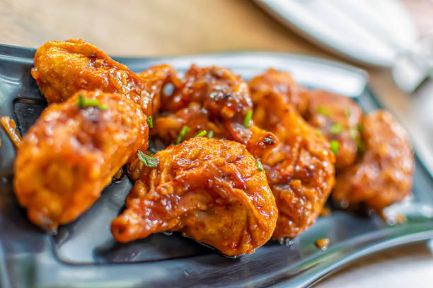 istock Pan fried chicken Momo served in a black plate over moody background. Selective focus 1218821130