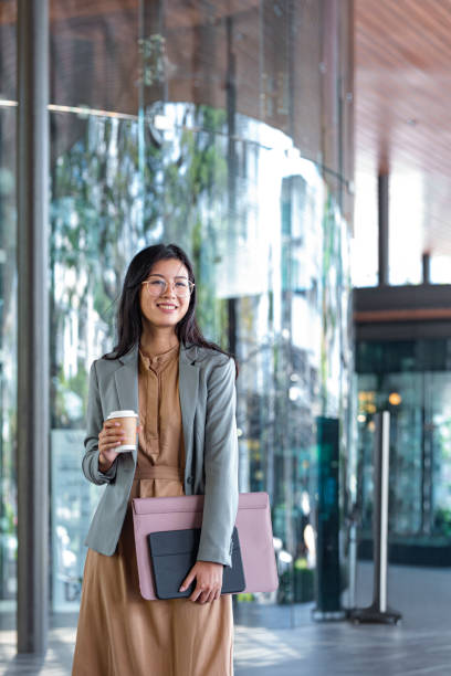 istock Happy Asian College Student Holding Coffee and Files 1218822066