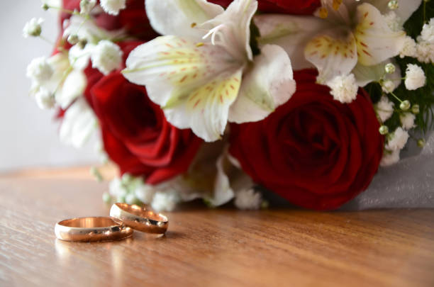 istock Gold wedding rings next to the bride's bouquet 1218822246