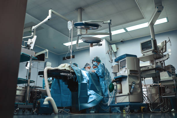 Surgical team operating on patient in theater in hospital stock photo