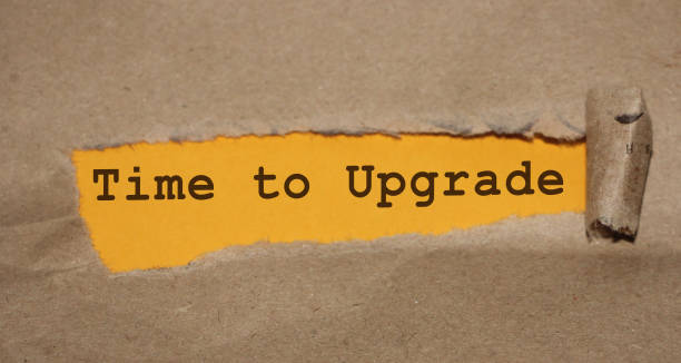istock TIME TO UPGRADE written under torn paper. Innovation update in busness startup concept 1218824227