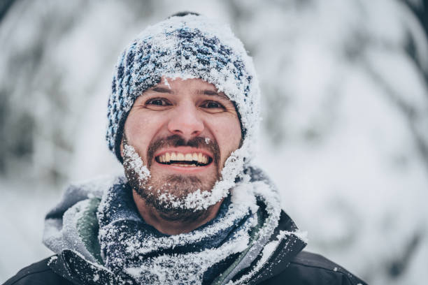 istock Male hiker in snowy forest smiles at camera 1218824779